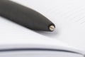 Ballpoint pen close-up lying in an open notebook Royalty Free Stock Photo