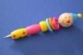 Ballpoint pen composed of many elements of colored wood and with the upper part in the shape of a clown head