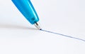 Ballpoint pen, drawing line in blue ink on white paper, close-up view Royalty Free Stock Photo