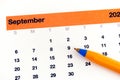 A ballpoint pen lying on a calendar that is showing September month