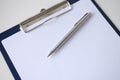 Ballpoint pen lying on clipboard with blank document closeup Royalty Free Stock Photo