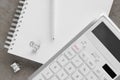 Ballpoint pen, notebook and calculator on gray table, flat lay Royalty Free Stock Photo