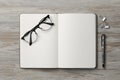 Ballpoint pen, notebook and glasses on wooden table, flat lay Royalty Free Stock Photo