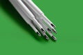 Ballpoint pen refills. Plastic rods for a ballpoint pen. Pile of white ink refills on a green Royalty Free Stock Photo