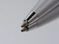 Ballpoint pen for signature on a mirror surface. On a gray background, macro tip