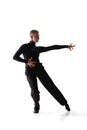 Portrait of young graceful male dancer, flexible man in black stage costume dancing ballroom dance isolated on white Royalty Free Stock Photo