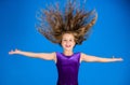Ballroom latin dance hairstyles. Kid girl with long hair wear dress on blue background. Hairstyle for dancer. How to