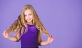 Ballroom latin dance hairstyles. Kid girl with long hair wear dress on violet background. Hairstyle for dancer. How to