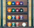 Balls for billiards, stand in a row in order on the rack for storing a set of inventory for playing pool Royalty Free Stock Photo