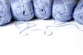 Balls of blue yarn and knitting needles. White background. Copy space. The concept of women `s needlework Royalty Free Stock Photo