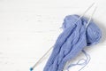 Balls of blue yarn and knitting needles. White background. Copy space. The concept of women `s needlework Royalty Free Stock Photo