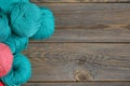 Balls of bright woolen yarn on old wood background. With Copy Space Royalty Free Stock Photo