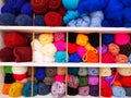 Balls of colored wool on the shelves