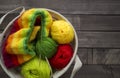 Balls of colored yarn.The process of knitting caps.