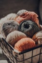 Balls of earth coloured yarn inside a basket, sunlight, selective focus Royalty Free Stock Photo