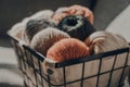 Balls of earth coloured yarn inside a basket, sunlight, selective focus Royalty Free Stock Photo