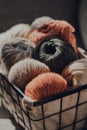 Balls of earth coloured yarn inside a basket, warm tones, selective focus Royalty Free Stock Photo