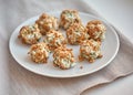 Balls of fish salad, breaded in pieces of pine nut