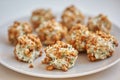 Balls of fish salad, breaded in pieces of pine nut