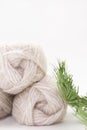 Balls of gray yarn and a spruce branch on a white background. Knitting, sewing, needlework, hobby, leisure