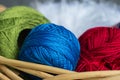 Balls of a green, blue and red yarn in a basket Royalty Free Stock Photo
