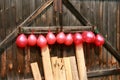 Balls are hanging on a wooden gate. Throw Darts at the target.