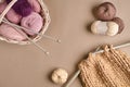 Balls of merino wool yarn, knitting on knitting needles on a beige surface. Top view Royalty Free Stock Photo