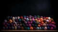 Balls of multicolored wool stacked on a dark background, different types of wool Royalty Free Stock Photo