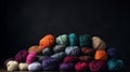 Balls of multicolored wool stacked on a dark background, different types of wool