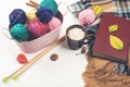 Balls of natural wool yarn and wooden knitting needles on white table Royalty Free Stock Photo