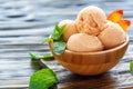 Balls peach ice cream in a wooden bowl. Royalty Free Stock Photo