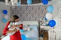 Balls in the room for a young mom. surprise at home. Celebration of the birth of a new family member. Mom with a child in the Royalty Free Stock Photo