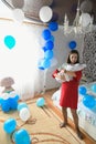 Balls in the room for a young mom. surprise at home. Celebration of the birth of a new family member. Mom with a child in the Royalty Free Stock Photo