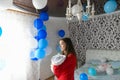 Balls in the room for a young mom. surprise at home. Celebration of the birth of a new family member. Mom with a child in the Royalty Free Stock Photo