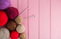 Balls of yarn in different colors with knitting needles