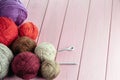 Balls of yarn in different colors with knitting needles on a background of pink Royalty Free Stock Photo