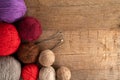 Balls of yarn in different colors with knitting needles on a background of rough wood Royalty Free Stock Photo