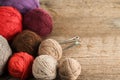 Balls of yarn in different colors with knitting needles on a background of rough wood texture. Royalty Free Stock Photo