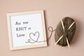 Balls of yarn and letter board with text All you knit is love. Royalty Free Stock Photo