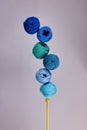 Balls yarn in the shades of blue in balance on knitting needle Royalty Free Stock Photo