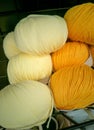Balls of yellow yarn on shelf in shope. Threads for needlework. Needlework background and homemade concept.