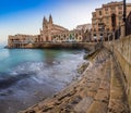 Balluta Bay, Malta - The steps of Balluta bay with the Church of our Lady Mount Carmel in Saint Julian`s Royalty Free Stock Photo