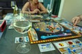 Balogunyom / Hungary - 08.12.2019: Glass of White wine with home entertainment Players playing board game Terraforming