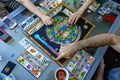 Balogunyom / Hungary -04.28.2019: Players placing pieces of the board game on the board while playing Terraforming Mars