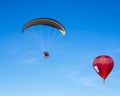 Paraglider withe red hot air balloon Royalty Free Stock Photo