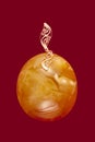 Baltic amber closeup on red background Royalty Free Stock Photo