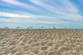 Baltic beach on a background of blue sky and white clouds. Umbrellas from the sun and the sea. Dune of white sand in the foregroun Royalty Free Stock Photo