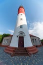 Baltic lighthouse, red white colors, bottom view. Most western russian lighthouse in Baltiysk city. Beautiful sunny weather