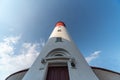 Baltic lighthouse, red white colors, bottom view. Most western russian lighthouse in Baltiysk city. Beautiful sunny weather