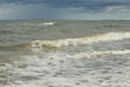 The Baltic Sea in August. Sand,seaweed on the shore, waves, beautiful clouds and the sun